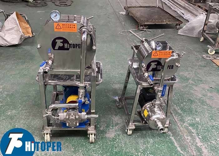 Solid liquid separation Plate and Frame Filter with pressure driven filtration and fluid discharge outlet for clean filtrate collection